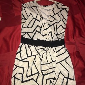 White mini dress with black geometric lines.